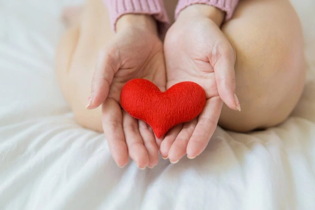 image of woman holding woollen love heart