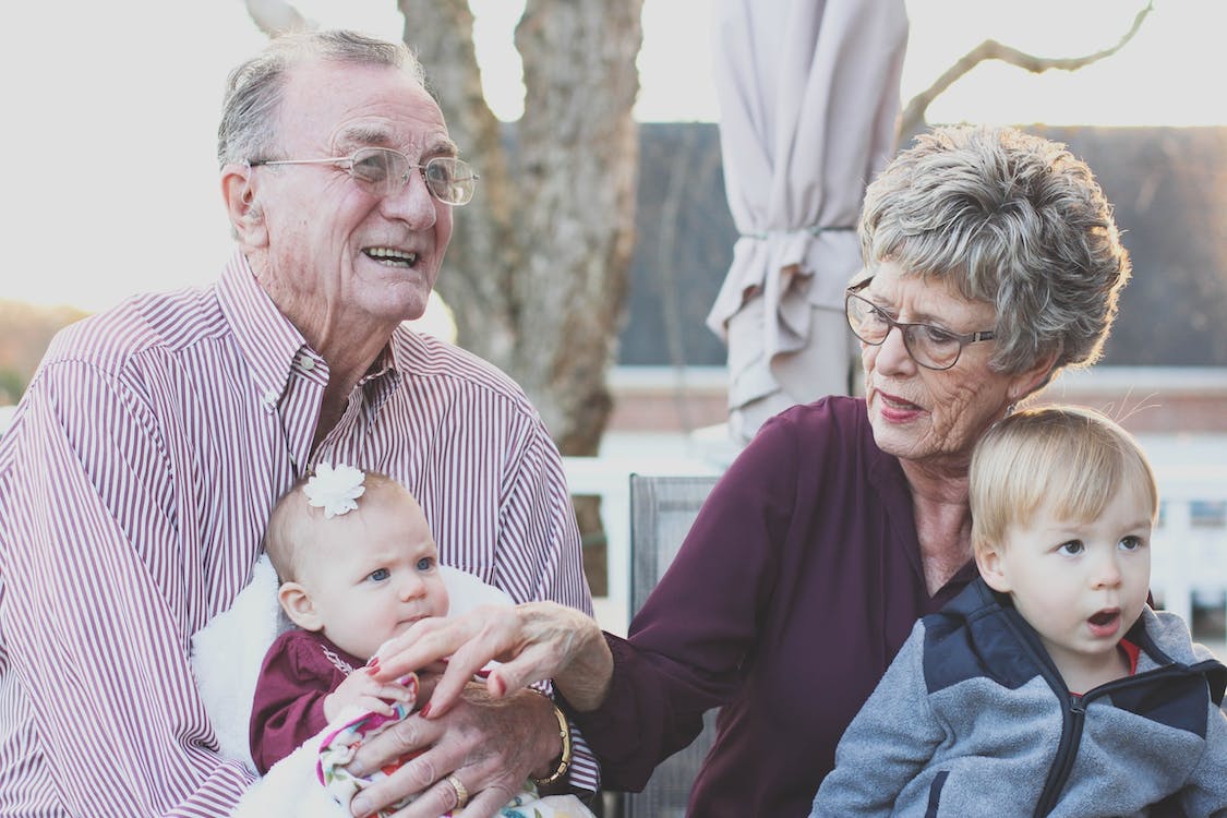 image of grandparents with baby grandchildren