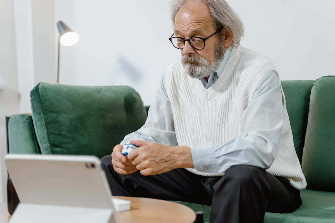 image of elderly man sat on sofa