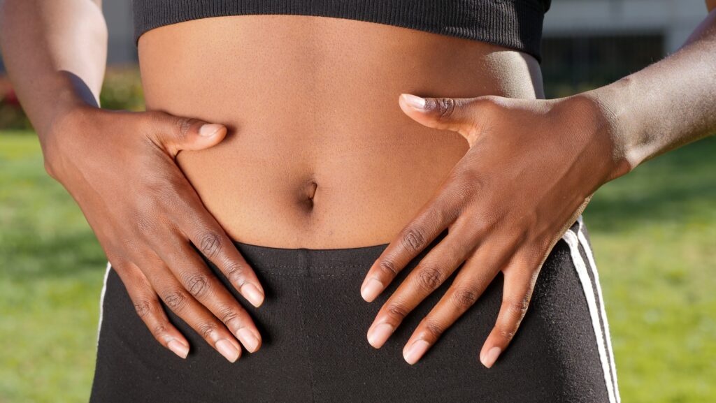 Photo of woman holding her stomach