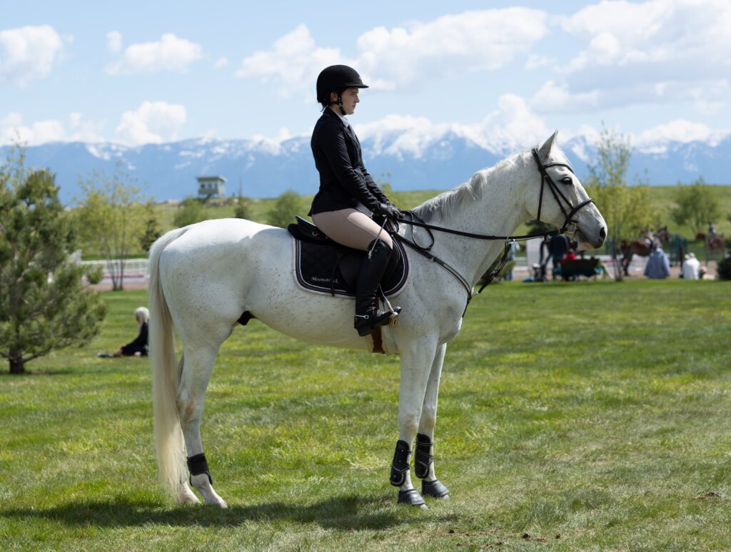 An image of a woman riding a horse