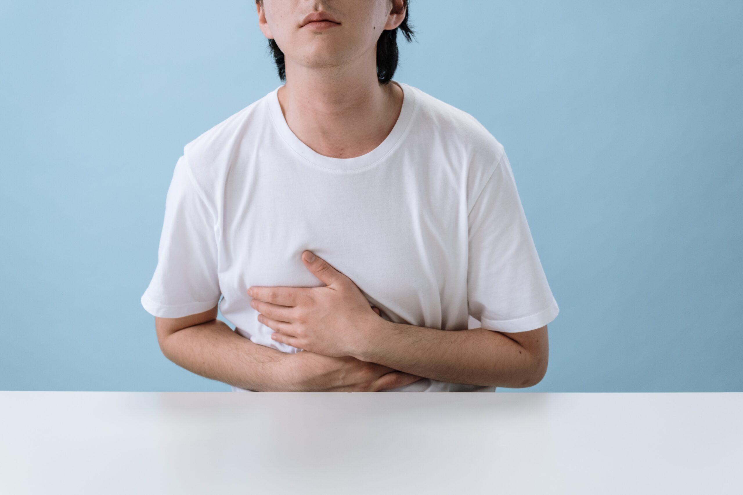 image of man with indigestion holding stomach