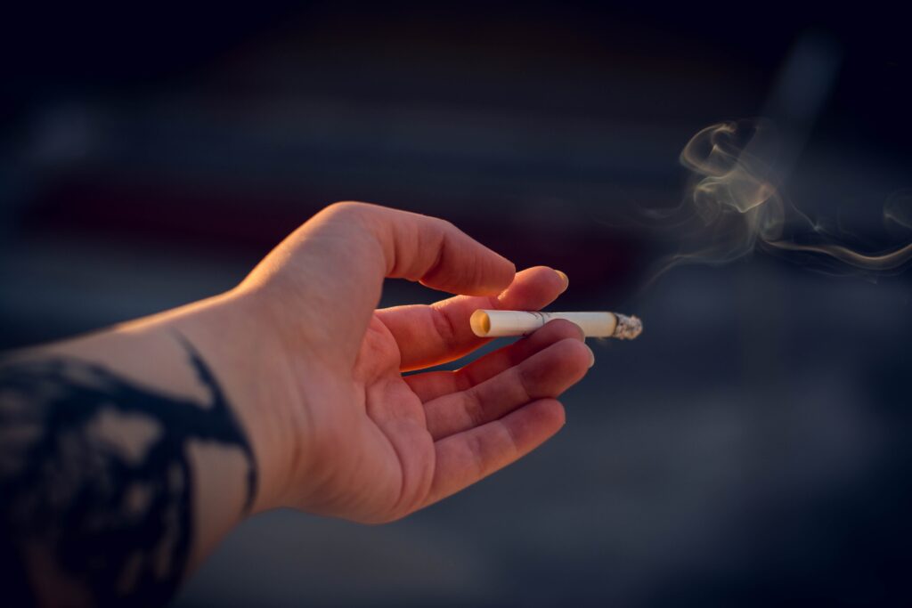 image of person holding a cigarette