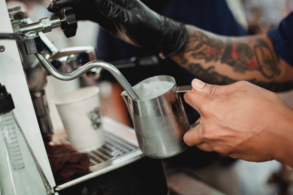 image of barista foaming milk for a coffee